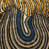 Close-up of a textured rug with wavy pattern in earthy tones.