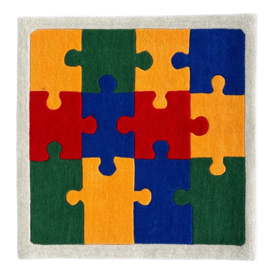 Colorful puzzle piece rug with red, orange, green, and blue pieces on a neutral background
