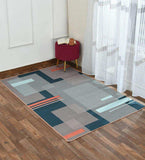 Modern Bauhaus geometric rug with blue, orange and neutral blocks in a living room, 8' x 10'