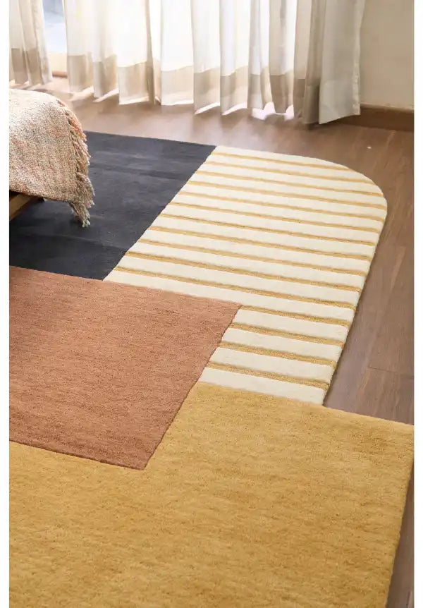 Hand-tufted abstract wool rug with sculpted color blocks.