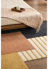 Premium wool rug featuring modern abstract color sections.