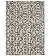 Cream geometric floral patterned rug with gray and beige details.