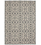 Cream geometric floral patterned rug with gray and beige details.