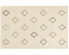 Modern cream geometric diamond rug for living room interiors.