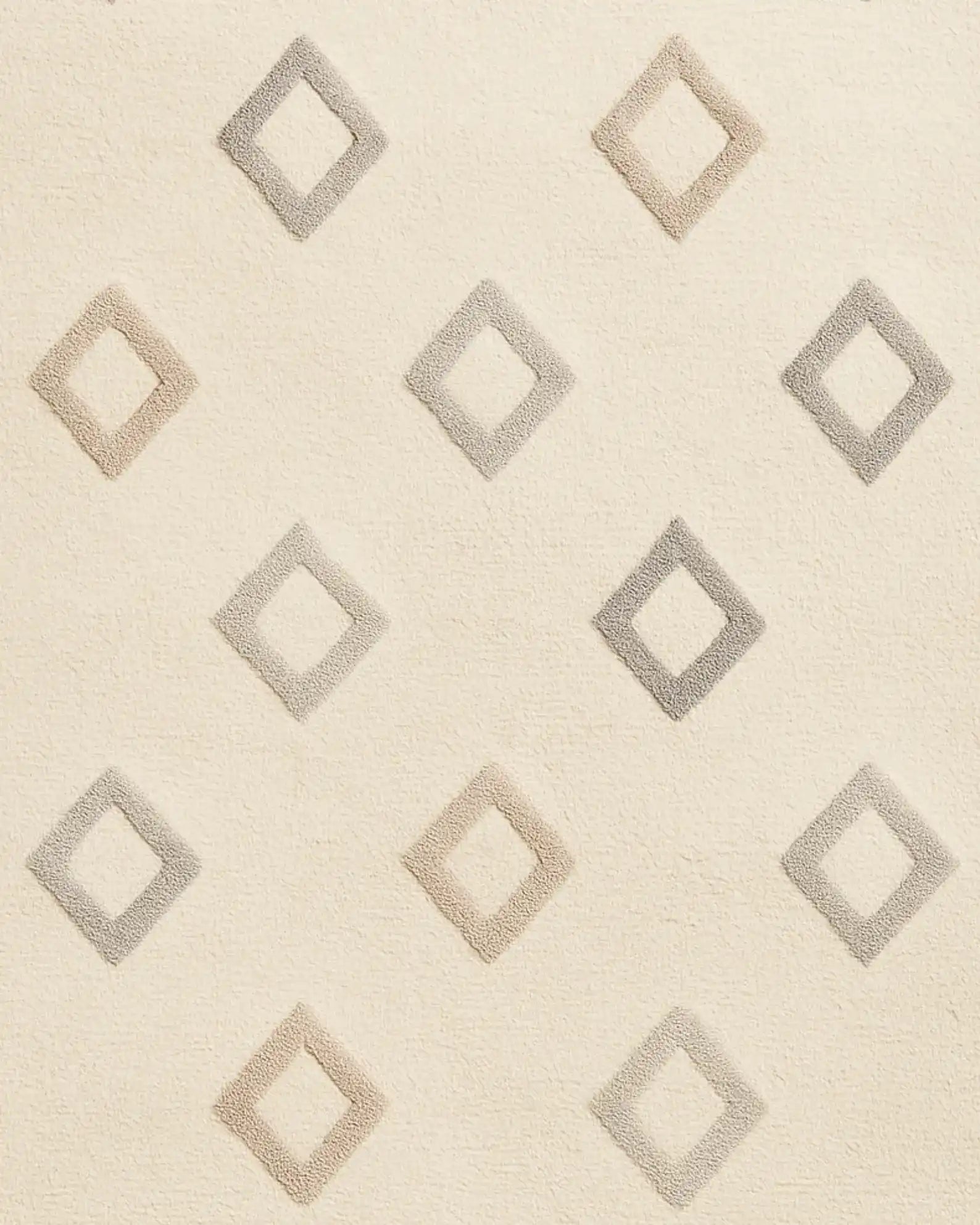 Hand-tufted wool rug in soft cream with subtle diamond texture.