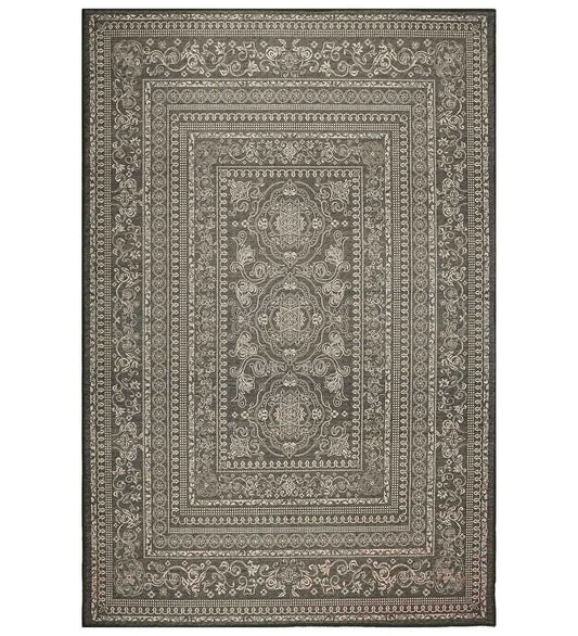 Dark ornate patterned machine washable rug.