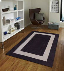 Modern hand-tufted rug with bold rectangular ivory frame on plum base