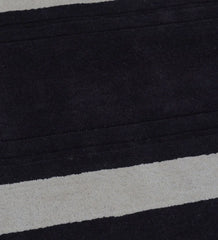 Luxury wool rug featuring plum background and ivory border