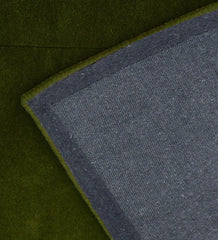 Handcrafted wool rug with subtle embossed border in green