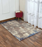Distressed mosaic patterned rug in neutral tones with hints of blue on wooden floor beside white curtain and red side stool