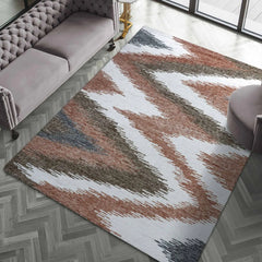 Modern rustic area rug with earthy tones and chevron pattern.