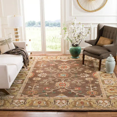 Elegant floral handwoven brown and beige rug in bright living room with white sofa, gray chair, and decorative vase