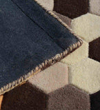 Close-up of geometric hexagon pattern hand-tufted runner rug with beige, brown, and cream tones