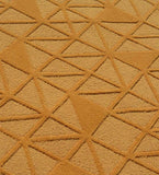 Handcrafted wool rug with embossed geometric texture in gold