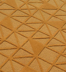 Handcrafted wool rug with embossed geometric texture in gold