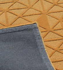 Modern gold rug with bold geometric triangle motif