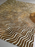 Luxury handwoven golden rug with modern abstract sunburst and wavy white lines pattern
