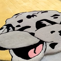 Statement hand-tufted yellow rug with black snake illustration and modern art style