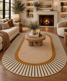 A large oval area rug with a cream center, a mustard-gold inner border, and black radial stripes around the edge, shown in a styled living room with a fireplace, sofa, and coffee table.
