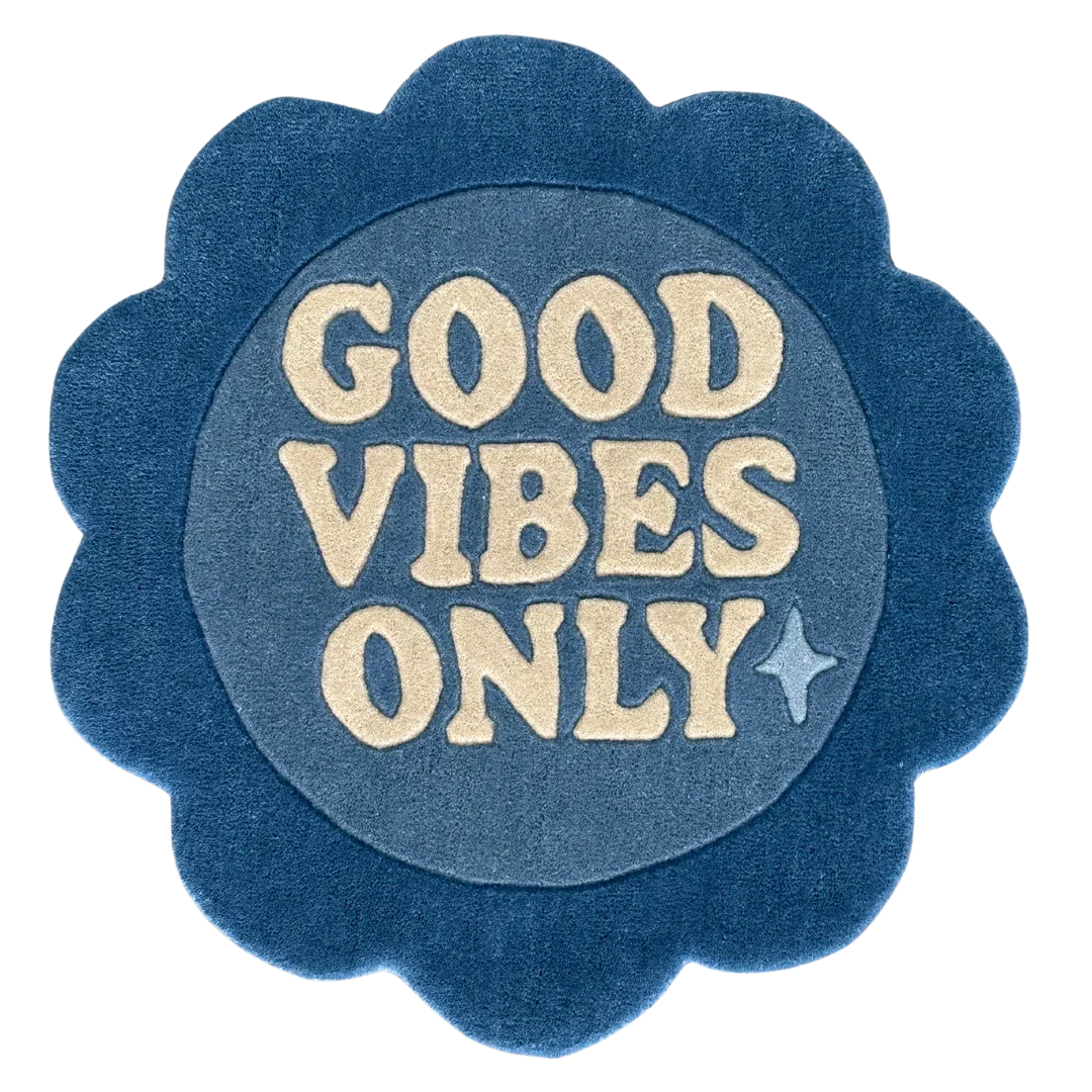 Blue circular rug flower shaped with 'Good Vibes Only'