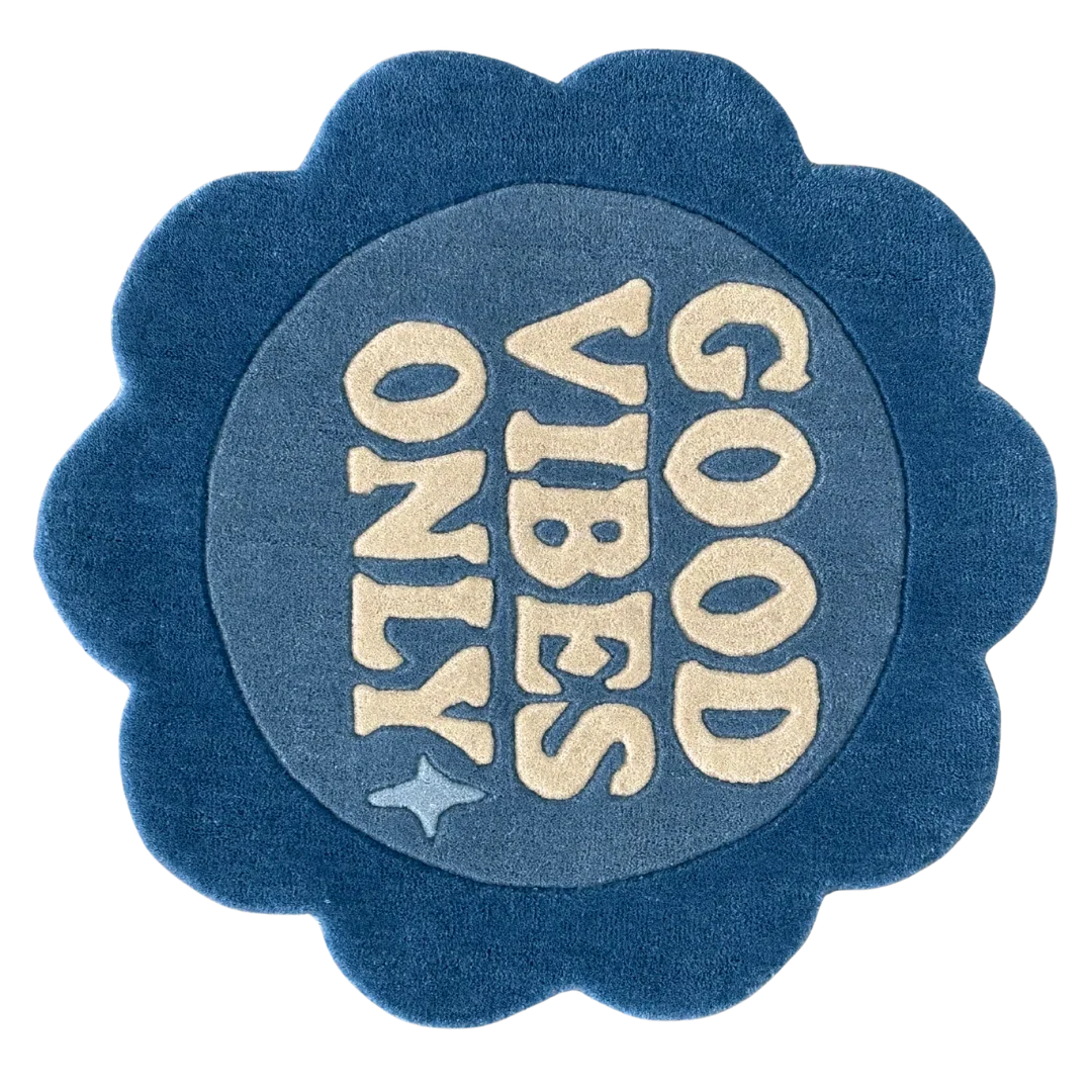 Round blue rug with 'Good Vibes Only' flower shaped