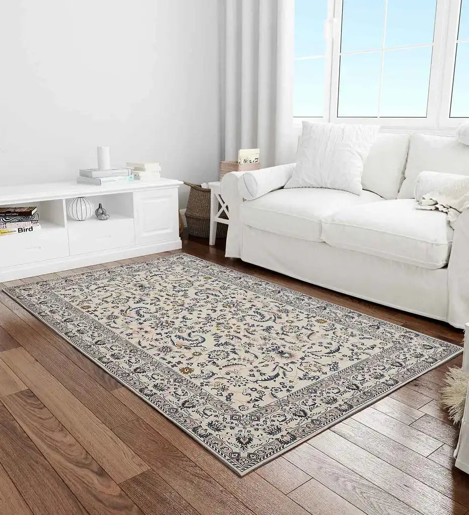 Gray medallion area rug in modern living room with white sofa and wood floor