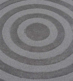 Gray modern hand-tufted round rug with concentric circle pattern in varying shades of gray