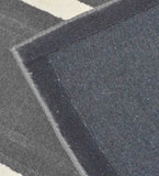 Close-up of luxurious gray and white hand-tufted runner rug with detailed weave and border
