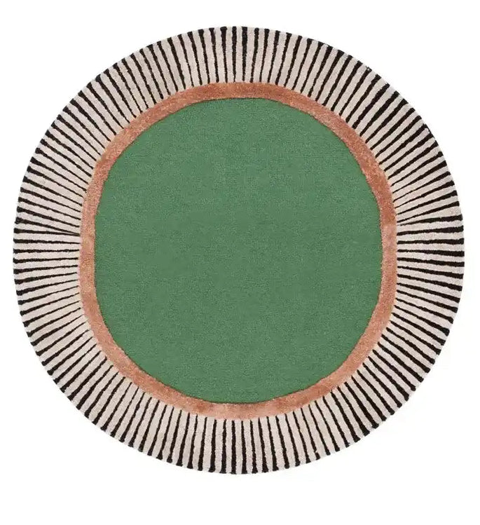 Round luxury handwoven rug with a green center, copper ring, and black-striped cream border