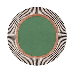 Round luxury handwoven rug with a green center, copper ring, and black-striped cream border