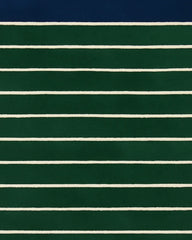 Green and navy hand-tufted wool rug with ivory lines.