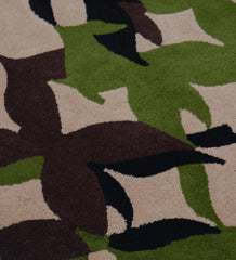 Luxury wool rug with abstract leaf motif on beige background