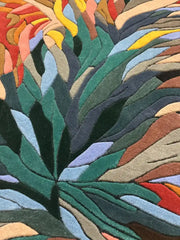 Colorful leaf-patterned luxury handwoven rug with green, blue, red, yellow, and brown abstract design