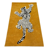 Mustard yellow hand-tufted luxury rug with black and white leopard pattern by Mannat Rugs