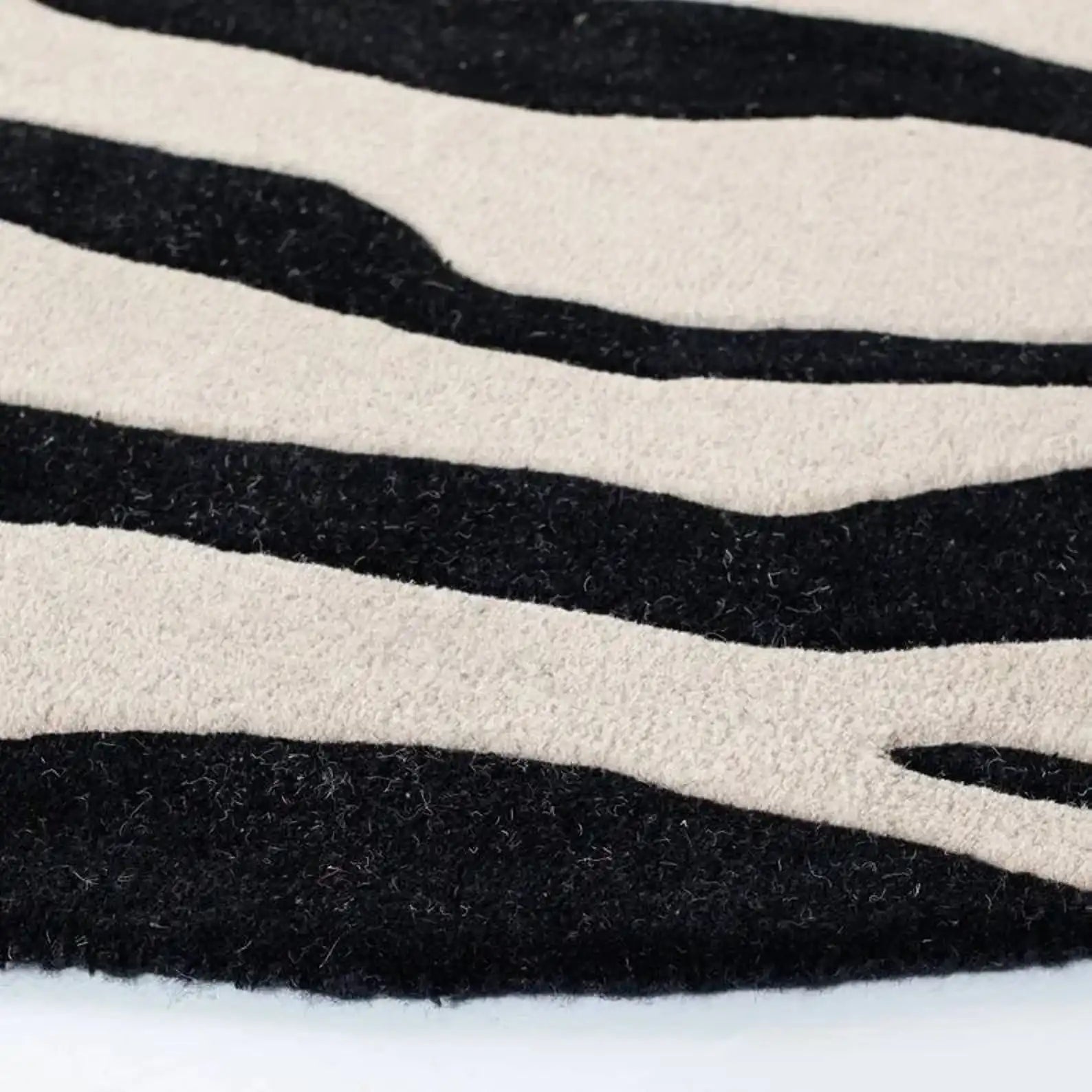 Bold zebra design wool rug in ivory base.