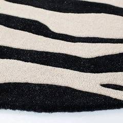 Bold zebra design wool rug in ivory base.