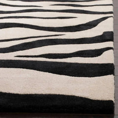 Handmade black and ivory animal print area rug.