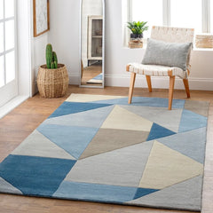 Modern wool rug with abstract angular design in soft blue tones.