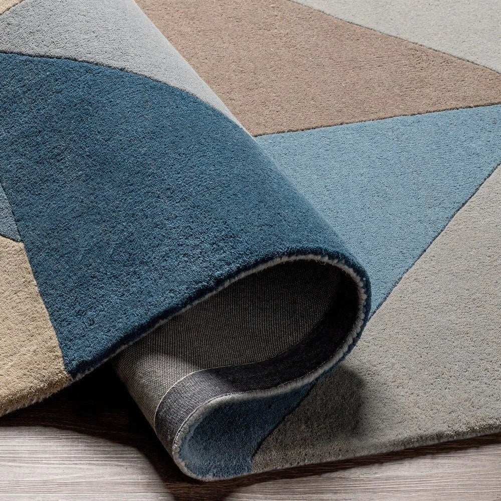 Abstract modern wool rug in blue, ivory, and taupe colors.