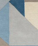 Luxury modern area rug with triangles in blue and gray shades.