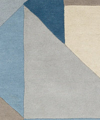 Luxury modern area rug with triangles in blue and gray shades.