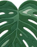 Premium wool tropical monstera rug with elegant tonal texture.