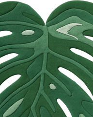 Premium wool tropical monstera rug with elegant tonal texture.