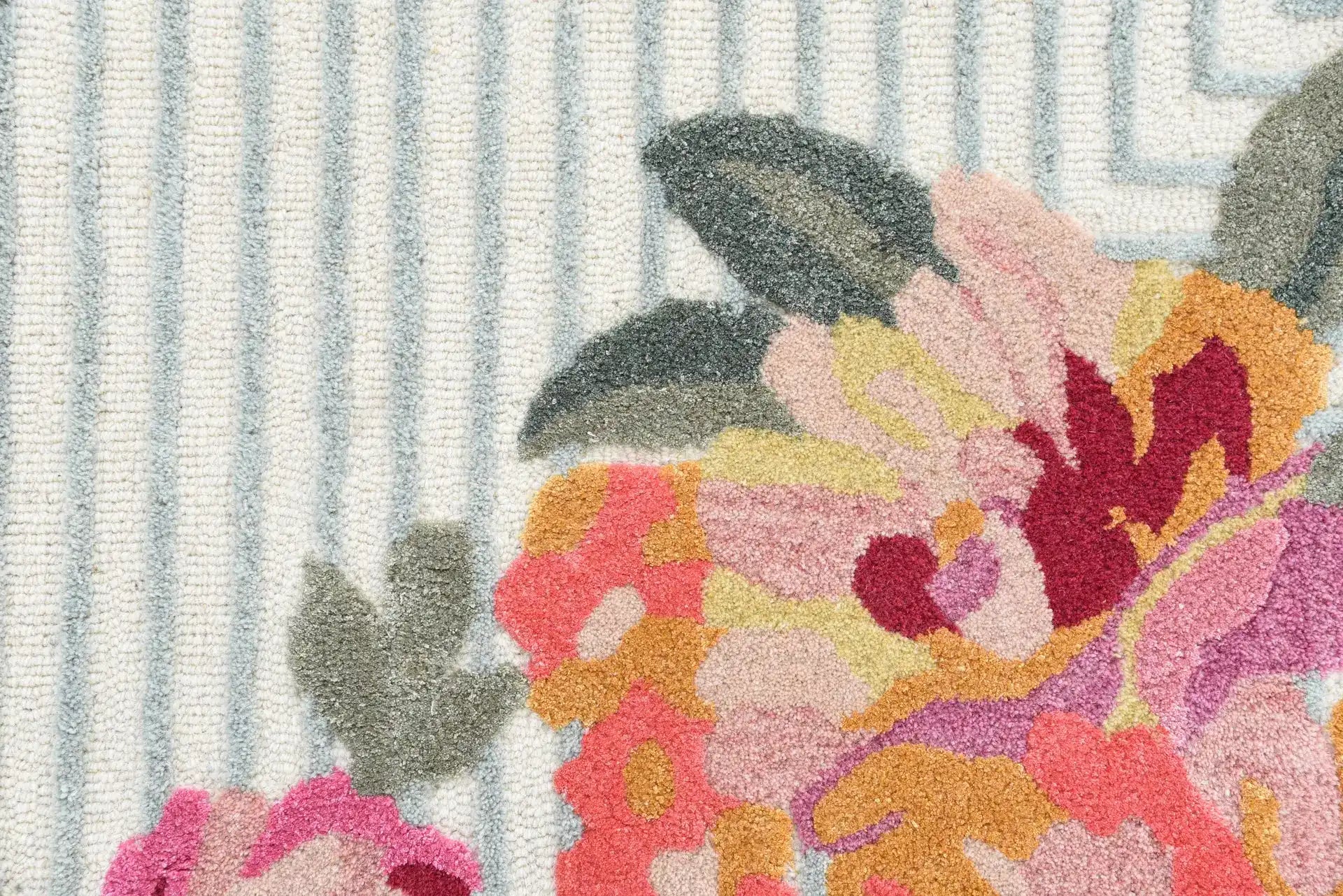 Luxury wool area rug with modern pink and yellow floral accents.