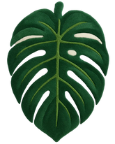 Hand-tufted tropical green monstera rug in luxury wool.