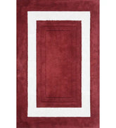 Red and white bordered hand-tufted wool rug with rectangle design
