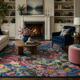 Living room with a floral rug, sofa, coffee table, and decorative items.