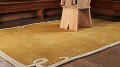 Luxury solid brown area rug with abstract corner design.