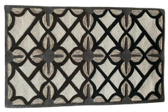Modern geometric wool rug with black and cream design.
