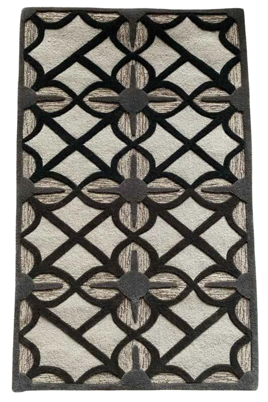 Hand-tufted beige rug with bold black lattice pattern.
